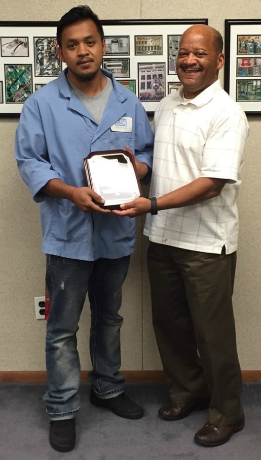 A picture of Johnny, one of our employees, getting an award. We're proud of our employee retention rate.